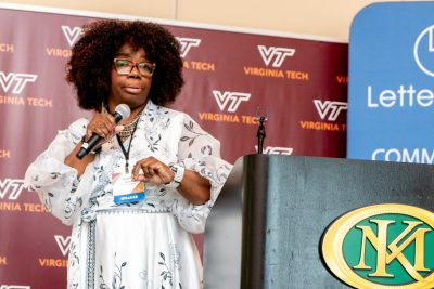 A woman speaks into a microphone.