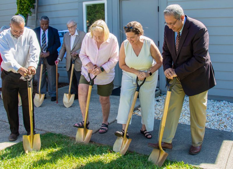A group of people using shovels at a groundbreaking ceremony