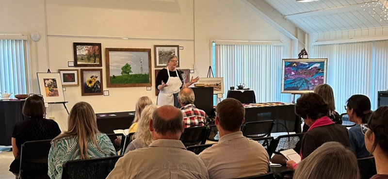 Bull Mountain Arts president Lora Mahaffey addresses the crowd at Rock Spring Art Show reception in 2023